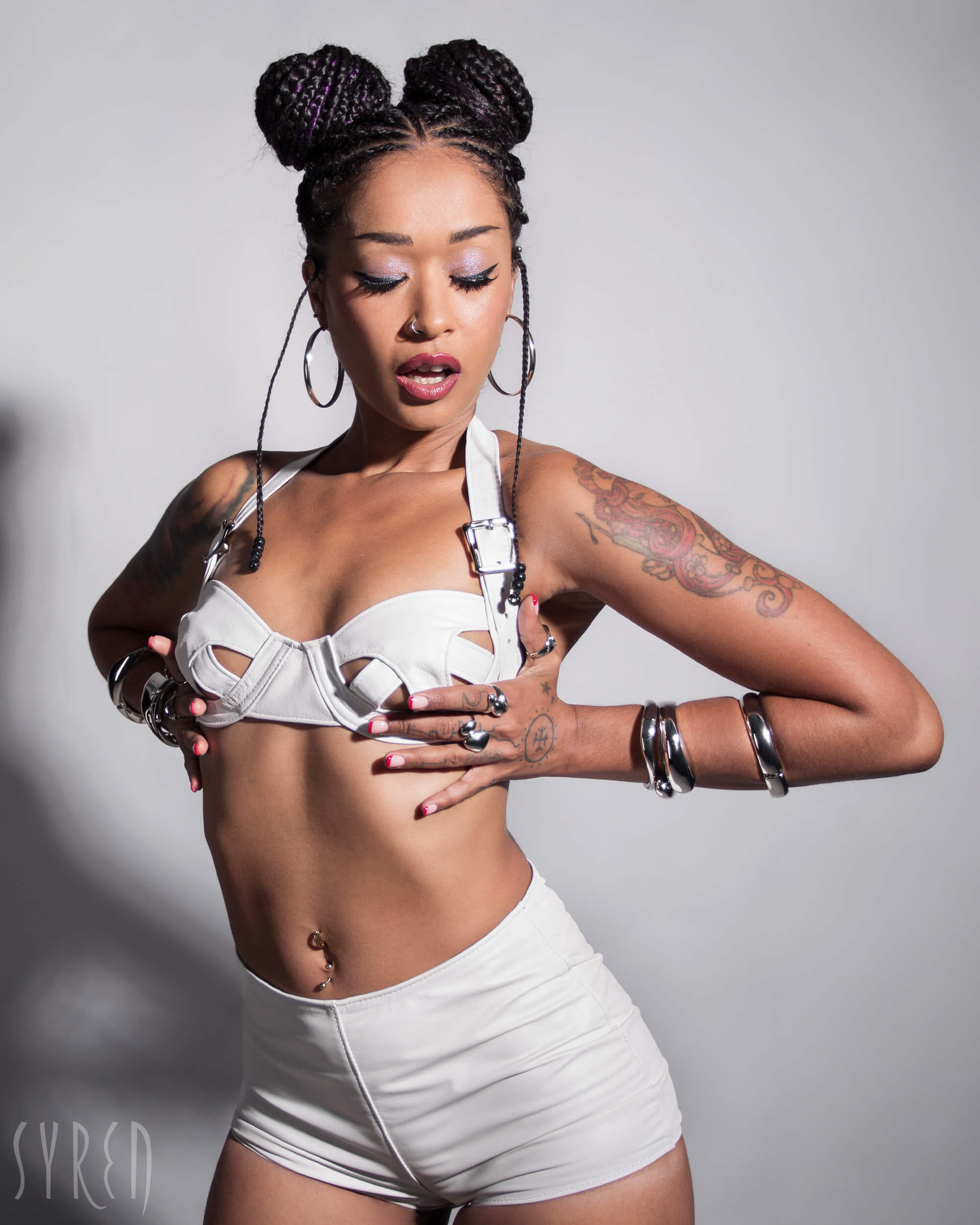 A lifestyle shot of a model wearing the Stormy Leather Showgirl bra against a light gray background.