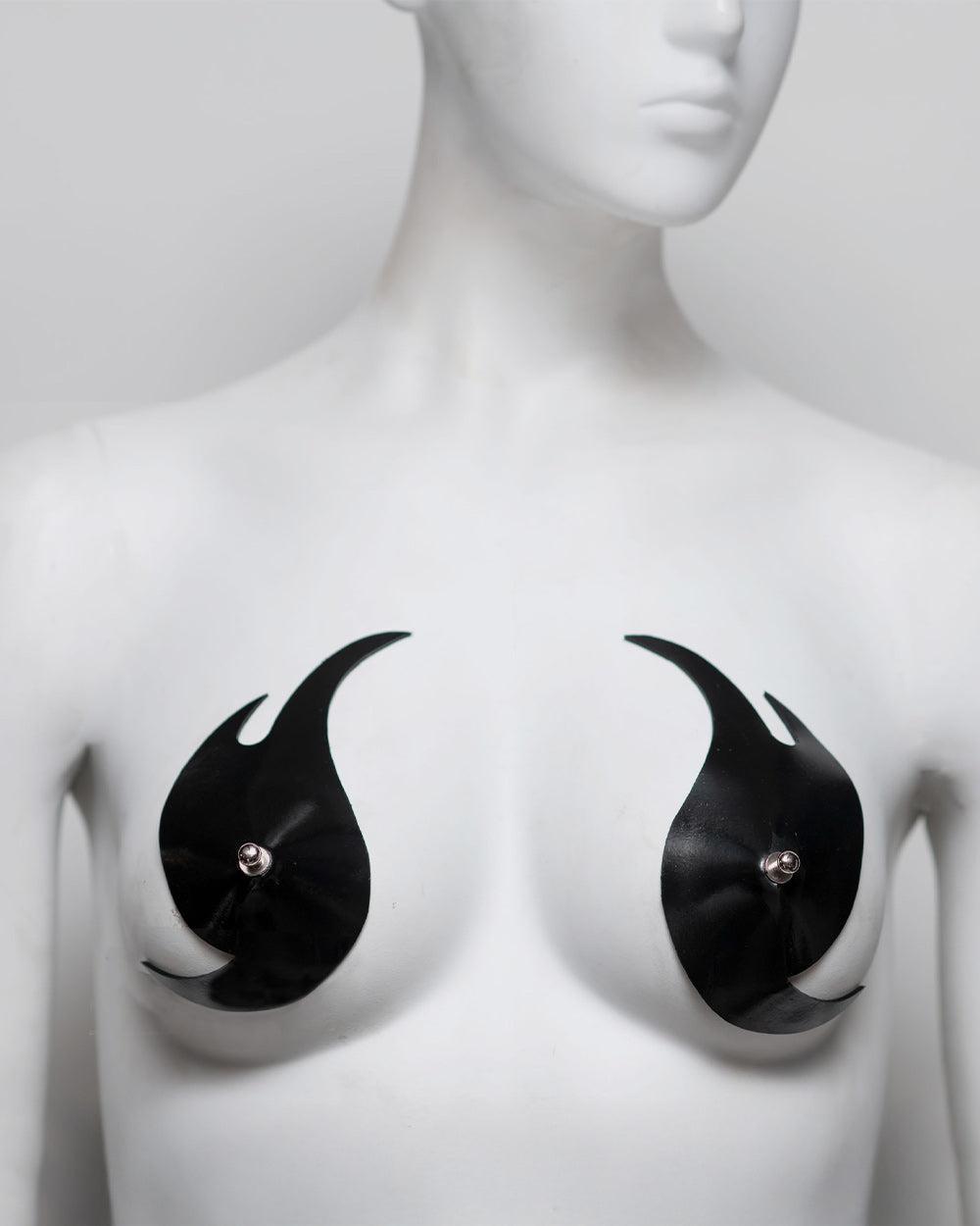 Black and white abstract art piece on a mannequin chest.