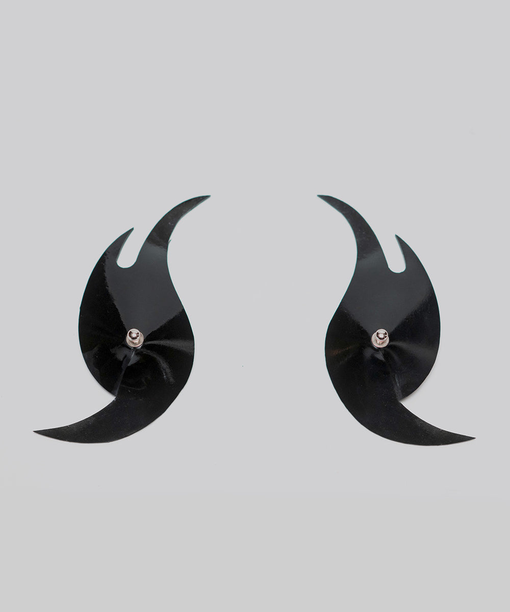 Pair of black crescent-shaped pasties on a light gray background