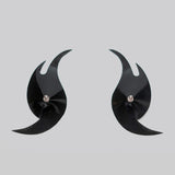 Pair of black crescent-shaped pasties on a light gray background