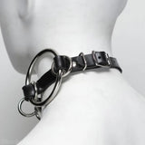 Black leather choker with metal rings on a mannequin neck.