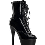 Black patent leather platform boot with high heel on a white background