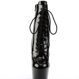 Black patent leather boot with high platform sole on a white background