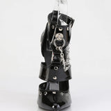 Black patent leather boot with chain detail on a white background