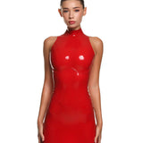 a female model is wearing the casey latex mini dress in red. She is standing in front of a white background. 