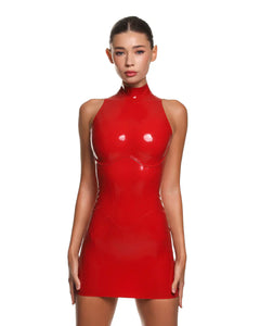 a female model is wearing the casey latex mini dress in red. She is standing in front of a white background. 