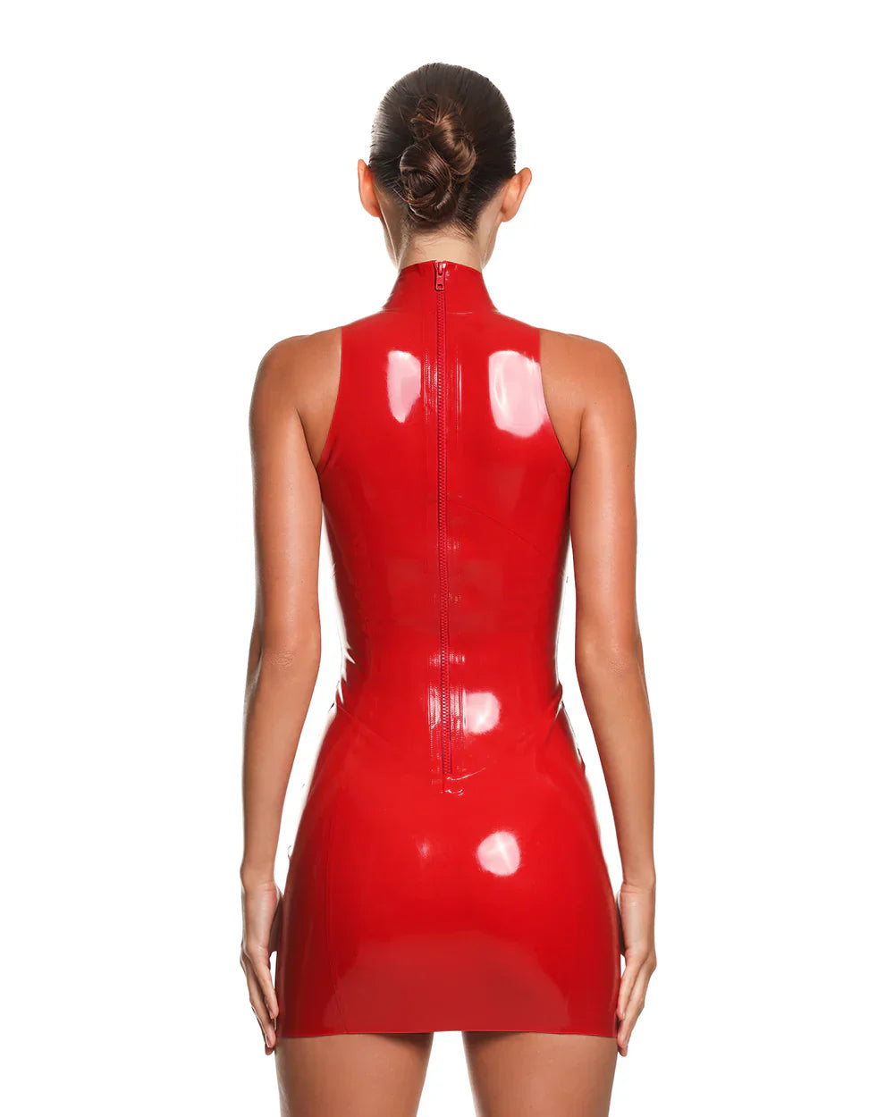 the back of a female model is shown wearing the casey latex mini dress in red. She is standing in front of a white background.