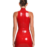 the back of a female model is shown wearing the casey latex mini dress in red. She is standing in front of a white background.
