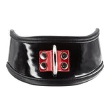 The Firecracker Patent Leather Posture Collar is shown against a blank background. The collar is patent leather with matte black leather lining. A piece of red leather secures a metal D-ring in the front.