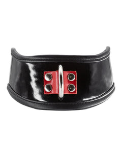 The Firecracker Patent Leather Posture Collar is shown against a blank background. The collar is patent leather with matte black leather lining. A piece of red leather secures a metal D-ring in the front.