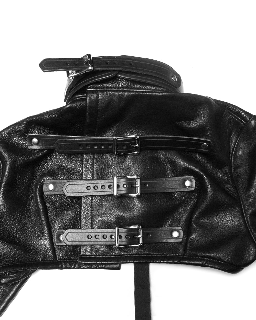 Close-up of a black leather jacket with silver buckles on a white background