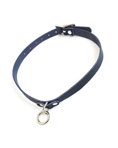 The Vondage Choker With O-Ring is shown against a blank background. It is made of a thin piece of black vegan leather and metal hardware.