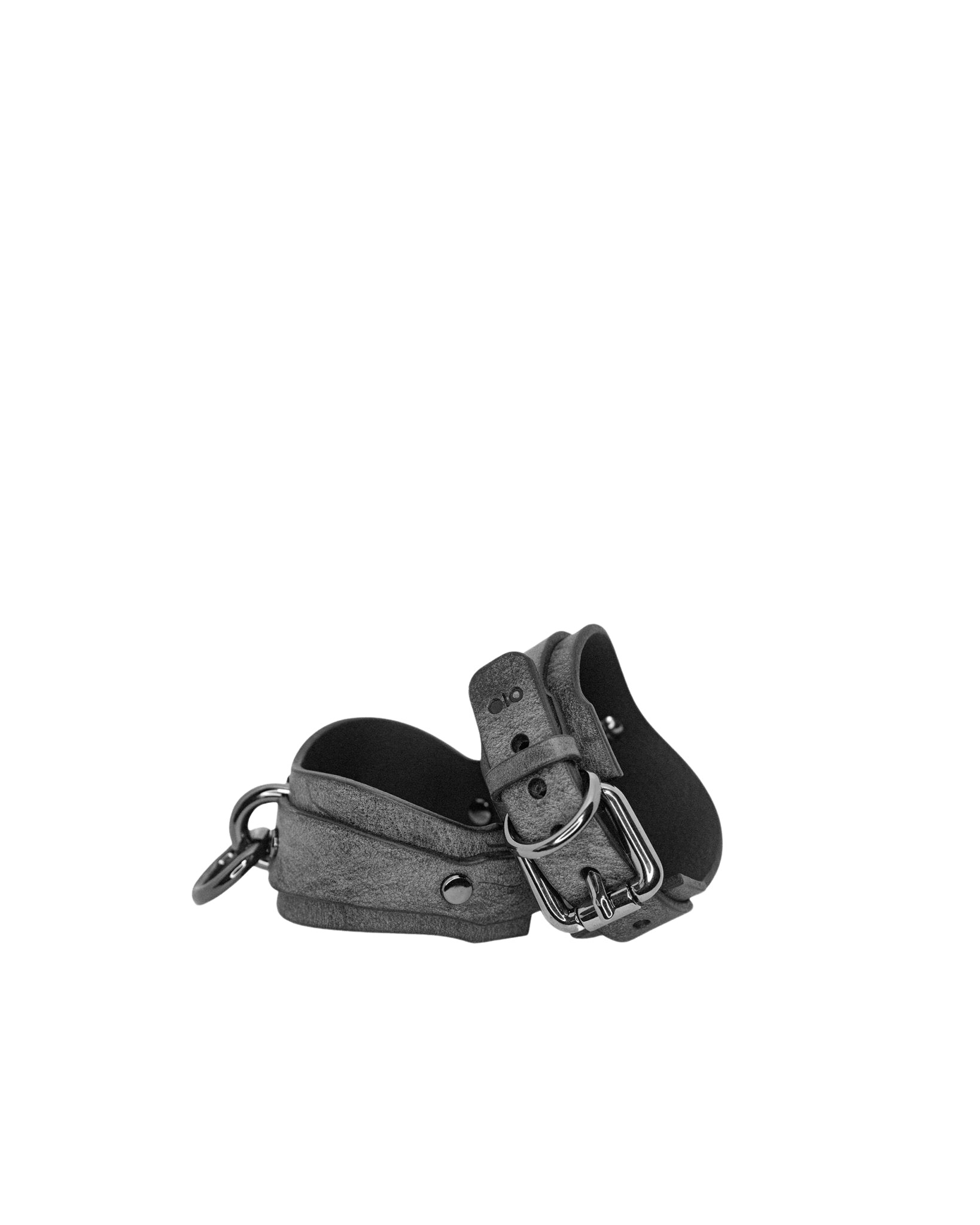 Black leather collar with metal buckle on a white background